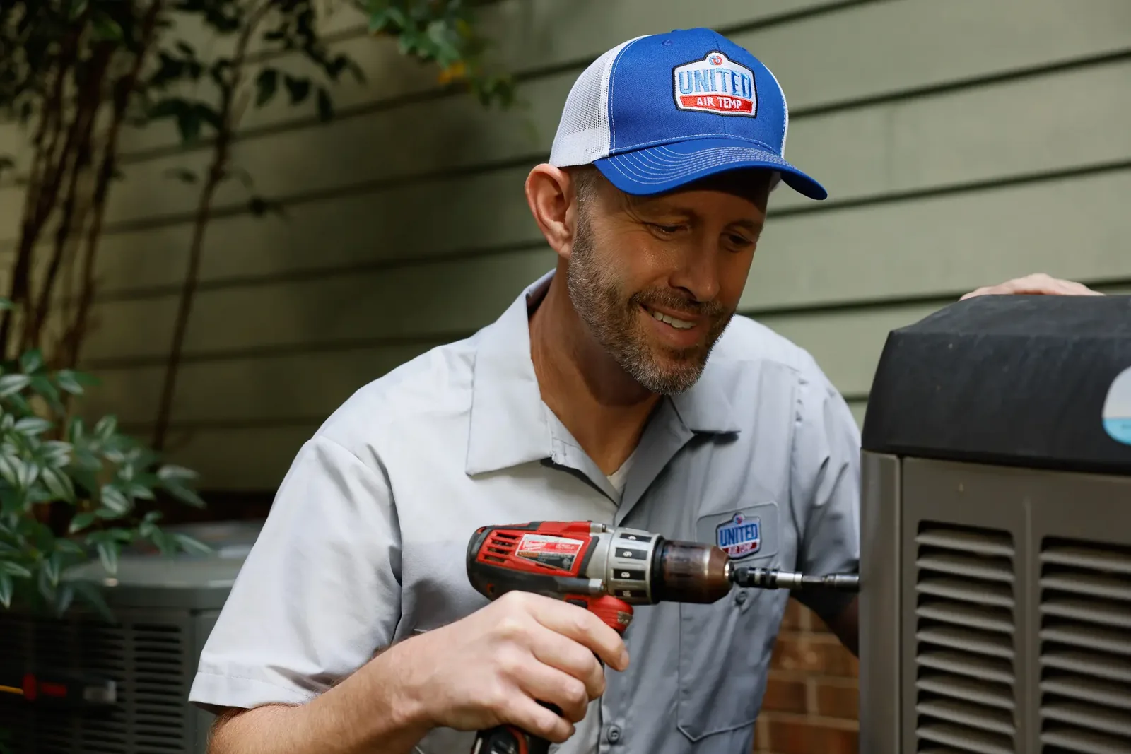 HVAC technician working on a residential outdoor unit