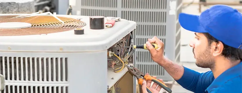 HVAC technician servicing a residential heating and cooling system in Lewiston New York